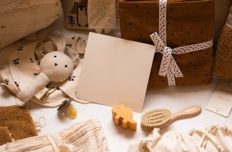A collection of baby care items including a crib, diapers, bottles, and toys arranged neatly.