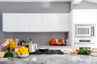 A neatly organized kitchen with labeled containers, clean countertops, and efficient storage solutions.