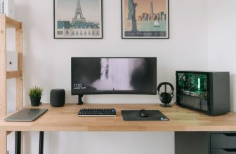 A clean workspace featuring simple tech tools like a planner, smartphone, and laptop, emphasizing organization and productivity.