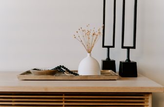 A cozy living room featuring small decorative items like cushions, candles, and plants that enhance the space's ambiance.